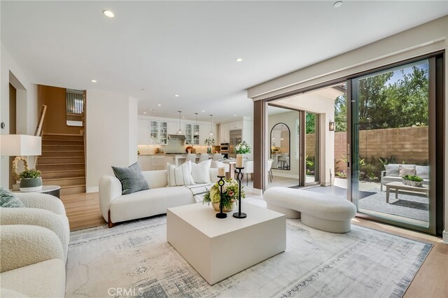 127 Toretta, Irvine, CA 92602 - living area with light wood-type flooring, recessed lighting, stairway, and baseboards