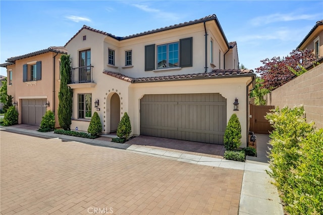 127 Toretta, Irvine, CA 92602 - mediterranean / spanish home featuring a balcony, a garage, stucco siding, and a tile roof