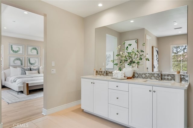 127 Toretta, Irvine, CA 92602 - ensuite bathroom with double vanity, backsplash, recessed lighting, and baseboards