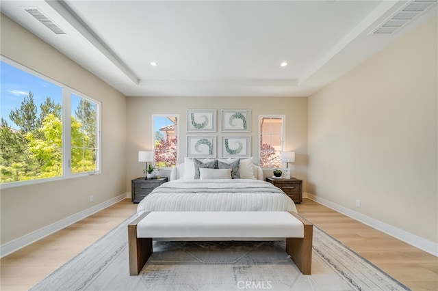 127 Toretta, Irvine, CA 92602 - bedroom featuring light wood-type flooring, a raised ceiling, baseboards, and recessed lighting