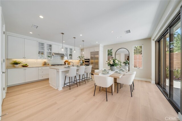 127 Toretta, Irvine, CA 92602 - dining area featuring light wood-style flooring, recessed lighting, and baseboards