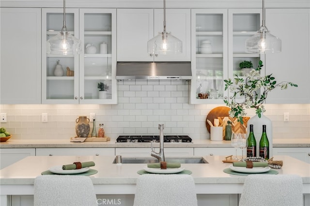 127 Toretta, Irvine, CA 92602 - kitchen with exhaust hood, gas stovetop, light countertops, and white cabinetry