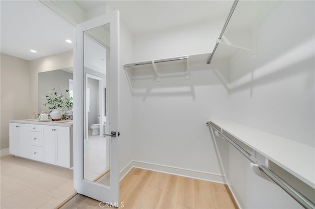 127 Toretta, Irvine, CA 92602 - walk in closet featuring light wood-style floors