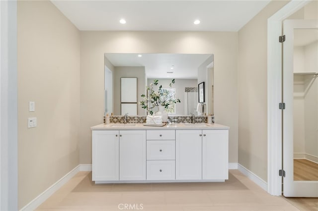 127 Toretta, Irvine, CA 92602 - full bath with double vanity, baseboards, recessed lighting, and a walk in closet