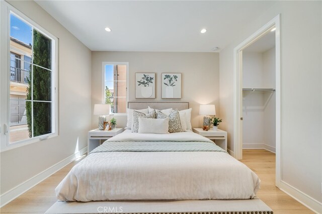 127 Toretta, Irvine, CA 92602 - bedroom featuring light wood finished floors, baseboards, a walk in closet, and recessed lighting