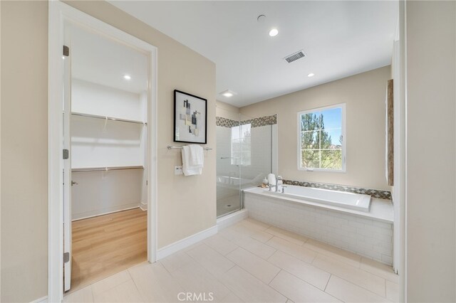 127 Toretta, Irvine, CA 92602 - full bathroom featuring a stall shower, a garden tub, a spacious closet, recessed lighting, and tile patterned floors