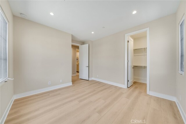 127 Toretta, Irvine, CA 92602 - unfurnished bedroom with light wood-type flooring, baseboards, recessed lighting, a spacious closet, and a closet
