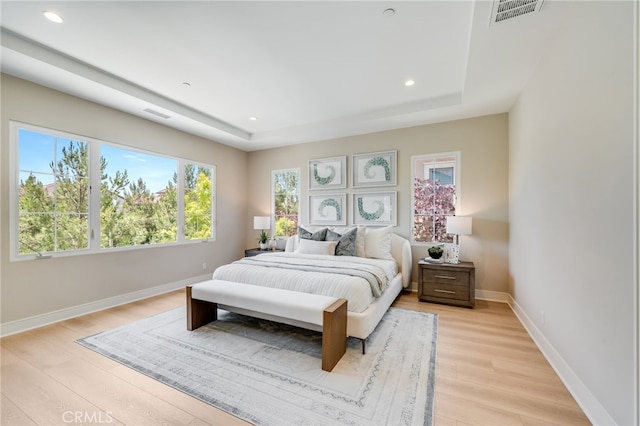 127 Toretta, Irvine, CA 92602 - bedroom featuring a raised ceiling, light wood finished floors, baseboards, and recessed lighting