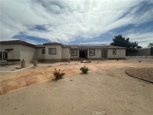 42500 20th St W, Lancaster, CA 93534 - view of front of house featuring solar panels and stucco siding