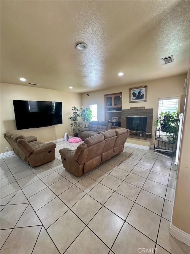 42500 20th St W, Lancaster, CA 93534 - living area with a textured ceiling, plenty of natural light, baseboards, light tile patterned flooring, and recessed lighting