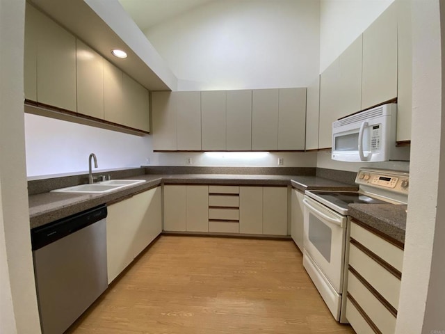 4793 Endeavor Ln, Carlsbad, CA 92008 - kitchen featuring white appliances, a sink, dark countertops, light wood-type flooring, and recessed lighting