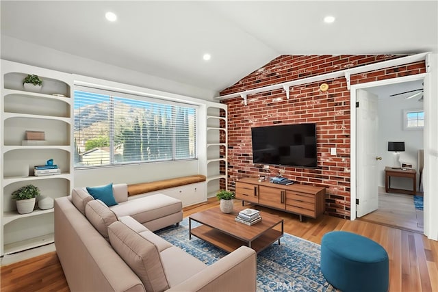 28918 Lillyglen Dr, Canyon Country, CA 91387 - living room with vaulted ceiling, wood finished floors, brick wall, and recessed lighting