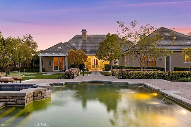 19103 Green Oaks Rd, Yorba Linda, CA 92886 - back of house with a chimney, french doors, a pool with connected hot tub, and stucco siding