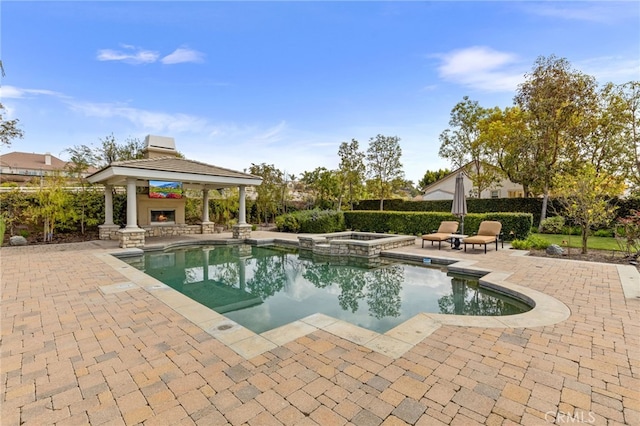 19103 Green Oaks Rd, Yorba Linda, CA 92886 - view of swimming pool featuring a gazebo, a lit fireplace, a patio area, and a pool with connected hot tub