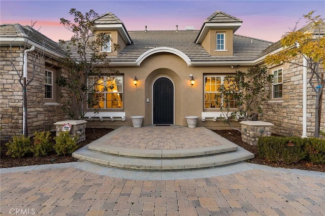 19103 Green Oaks Rd, Yorba Linda, CA 92886 - exterior entry at dusk with stucco siding