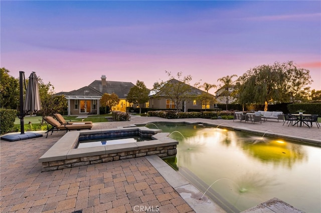 19103 Green Oaks Rd, Yorba Linda, CA 92886 - pool at dusk with a patio, an outdoor living space, a pool with connected hot tub, an outdoor structure, and an exterior structure