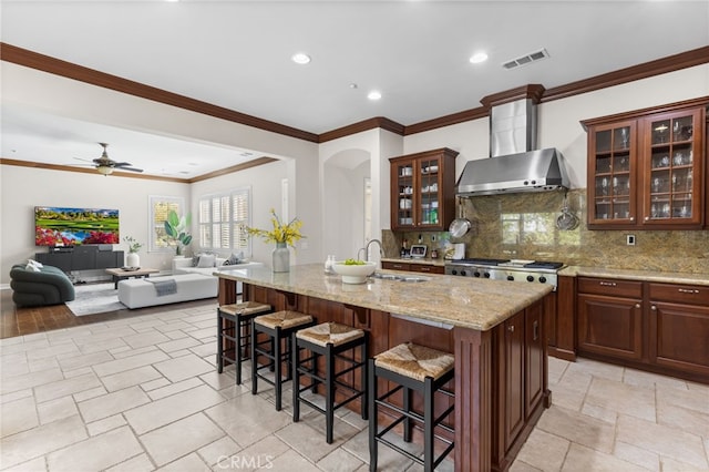 19103 Green Oaks Rd, Yorba Linda, CA 92886 - kitchen with wall chimney range hood, a breakfast bar, backsplash, recessed lighting, and ornamental molding