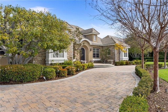 19103 Green Oaks Rd, Yorba Linda, CA 92886 - view of front of house featuring stone siding, stucco siding, decorative driveway, and a tiled roof