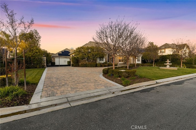 19103 Green Oaks Rd, Yorba Linda, CA 92886 - view of front of house featuring decorative driveway, a front yard, roof mounted solar panels, and a garage