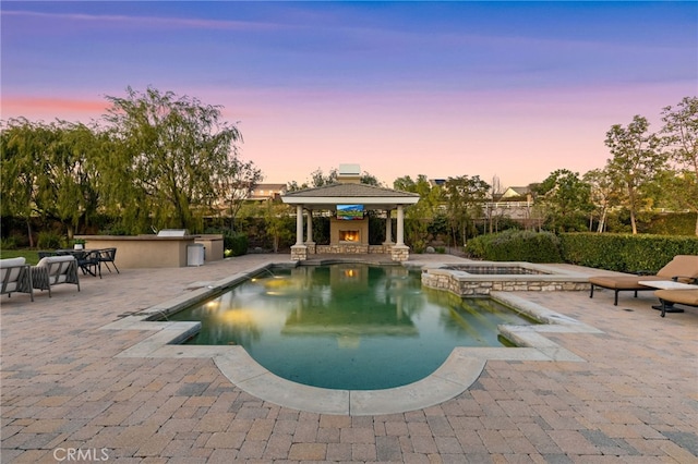 19103 Green Oaks Rd, Yorba Linda, CA 92886 - view of swimming pool featuring a warm lit fireplace, area for grilling, a gazebo, a patio, and a pool with connected hot tub