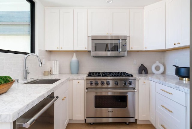 131 46th St, Newport Beach, CA 92663 - kitchen featuring stainless steel appliances, a sink, backsplash, and white cabinets
