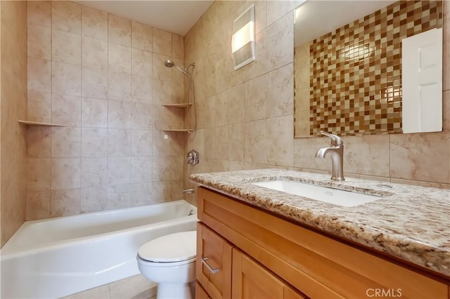 421 S La Fayette Park Pl Unit 701, Los Angeles, CA 90057 - bathroom featuring tile walls, vanity, toilet, washtub / shower combination, and decorative backsplash