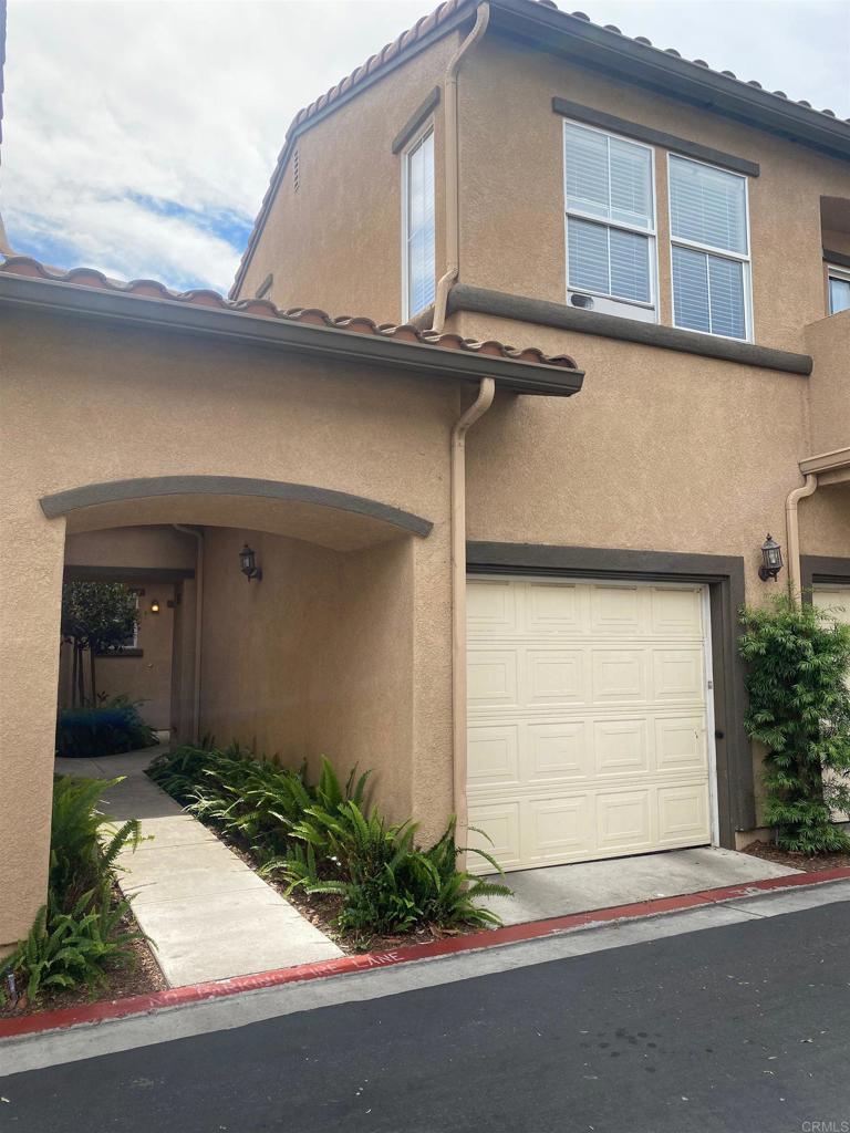 645 Sumner Way Unit 3, Oceanside, CA 92058 - view of front facade with a garage, stucco siding, and a tiled roof