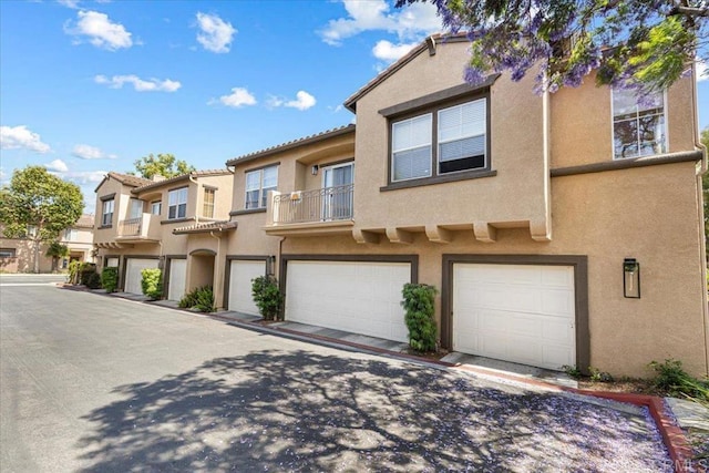 645 Sumner Way Unit 3, Oceanside, CA 92058 - townhome / multi-family property with stucco siding, an attached garage, a balcony, and a tile roof
