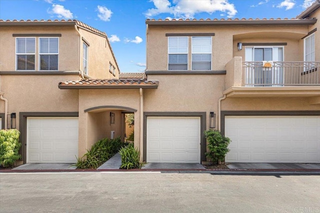 645 Sumner Way Unit 3, Oceanside, CA 92058 - view of front of home with stucco siding, a balcony, an attached garage, and a tiled roof