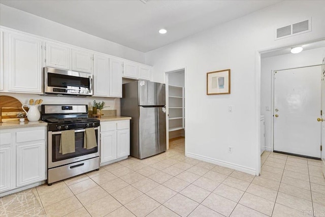 645 Sumner Way Unit 3, Oceanside, CA 92058 - kitchen with stainless steel appliances, light countertops, white cabinetry, light tile patterned floors, and recessed lighting