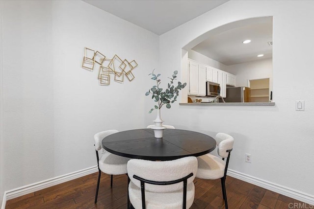 645 Sumner Way Unit 3, Oceanside, CA 92058 - dining area with arched walkways, dark wood finished floors, and recessed lighting