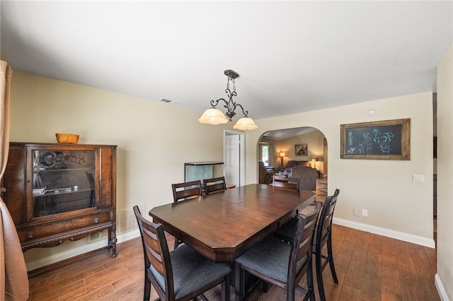 32642 Durango Ct, Wildomar, CA 92595 - dining space with arched walkways, wood finished floors, and baseboards