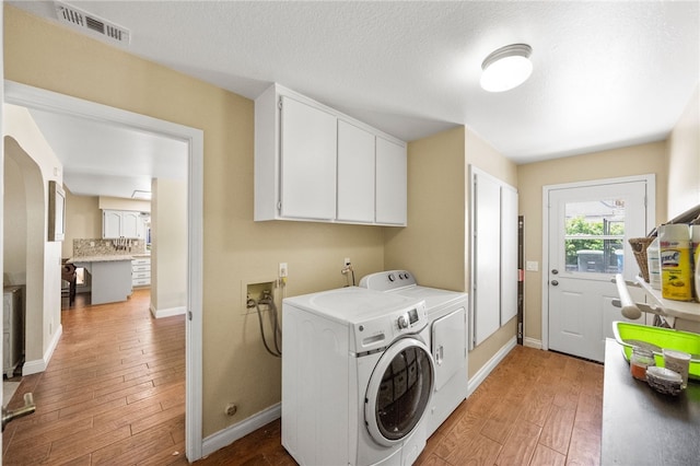 32642 Durango Ct, Wildomar, CA 92595 - laundry room with cabinet space, washer and dryer, light wood finished floors, and baseboards