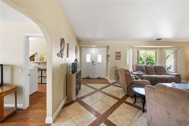 32642 Durango Ct, Wildomar, CA 92595 - living room featuring arched walkways, baseboards, and separate washer and dryer