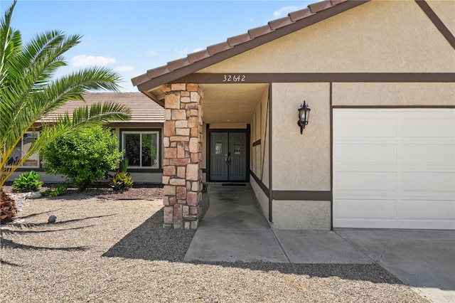 32642 Durango Ct, Wildomar, CA 92595 - doorway to property with stucco siding, a tiled roof, and a garage