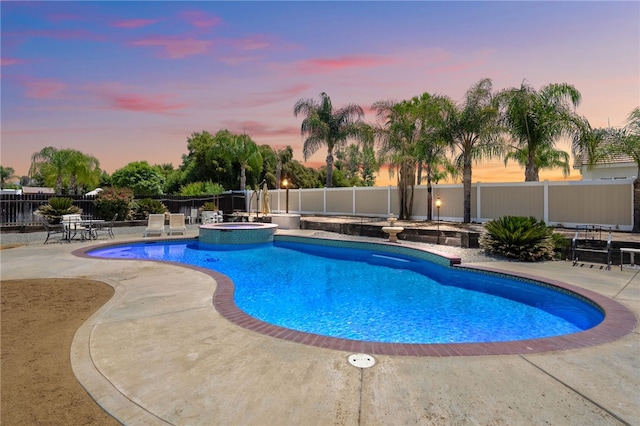 32642 Durango Ct, Wildomar, CA 92595 - pool at dusk with a patio area, a fenced backyard, and a pool with connected hot tub