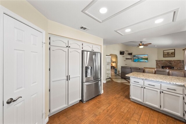 32642 Durango Ct, Wildomar, CA 92595 - kitchen with stainless steel refrigerator with ice dispenser, ceiling fan, arched walkways, open floor plan, and recessed lighting