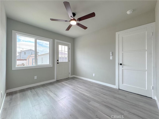 1976 E 112th St, Los Angeles, CA 90059 - doorway with a ceiling fan, baseboards, and wood finished floors