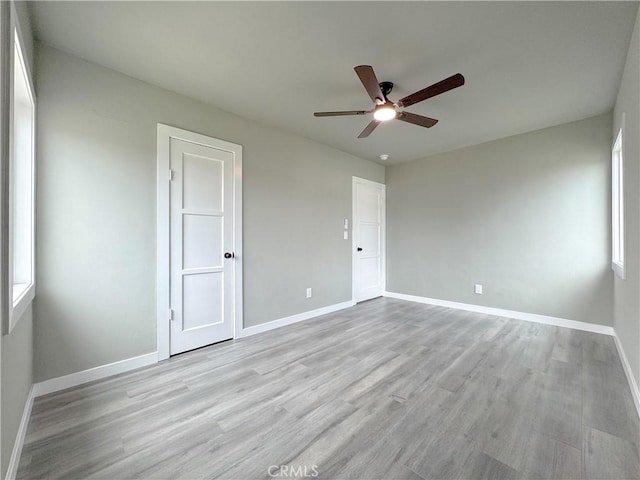 1976 E 112th St, Los Angeles, CA 90059 - unfurnished bedroom featuring baseboards, light wood finished floors, and ceiling fan