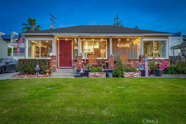 4002 Camerino St, Lakewood, CA 90712 - view of front of property featuring board and batten siding, a front lawn, covered porch, and brick siding