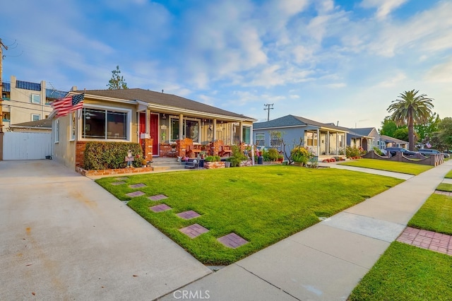 4002 Camerino St, Lakewood, CA 90712 - view of front of house with a front lawn, a gate, a porch, and driveway