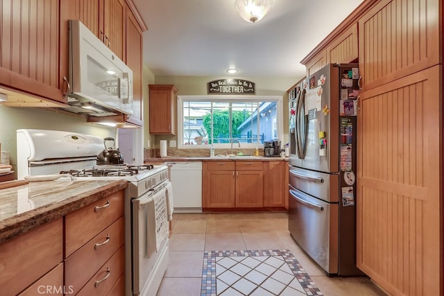 4002 Camerino St, Lakewood, CA 90712 - kitchen featuring white appliances, light tile patterned floors, light stone countertops, and a sink