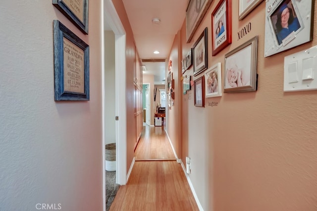 4002 Camerino St, Lakewood, CA 90712 - hall featuring light wood-type flooring, baseboards, recessed lighting, and a textured wall