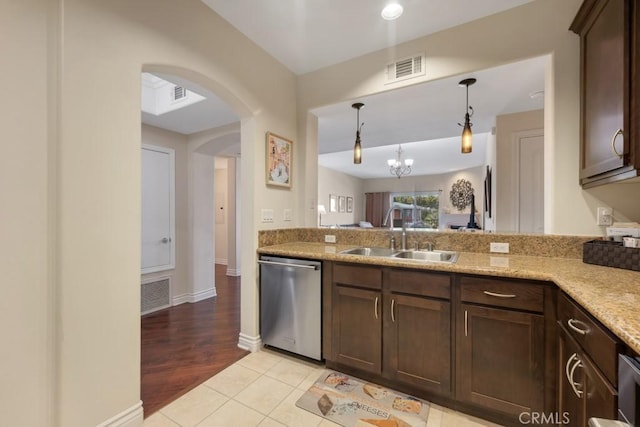 13200 Moorpark St Unit 201, Sherman Oaks, CA 91423 - kitchen featuring stainless steel dishwasher, a sink, dark brown cabinets, arched walkways, and decorative light fixtures