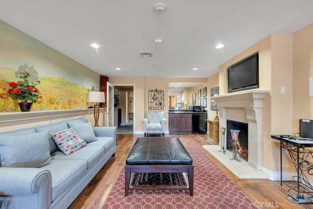 13200 Moorpark St Unit 201, Sherman Oaks, CA 91423 - living area with wood finished floors, baseboards, a lit fireplace, and recessed lighting
