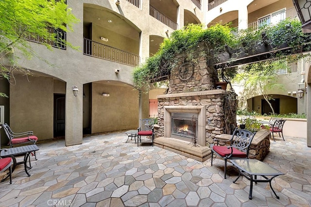 13200 Moorpark St Unit 201, Sherman Oaks, CA 91423 - view of patio / terrace featuring an outdoor stone fireplace