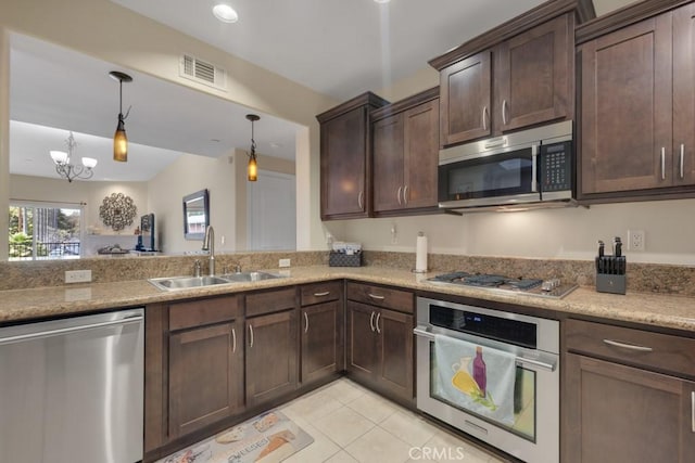 13200 Moorpark St Unit 201, Sherman Oaks, CA 91423 - kitchen featuring stainless steel appliances, a sink, dark brown cabinetry, light tile patterned floors, and decorative light fixtures