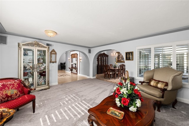 1738 N Ukiah Way, Upland, CA 91784 - carpeted living room with arched walkways, baseboards, and ornamental molding