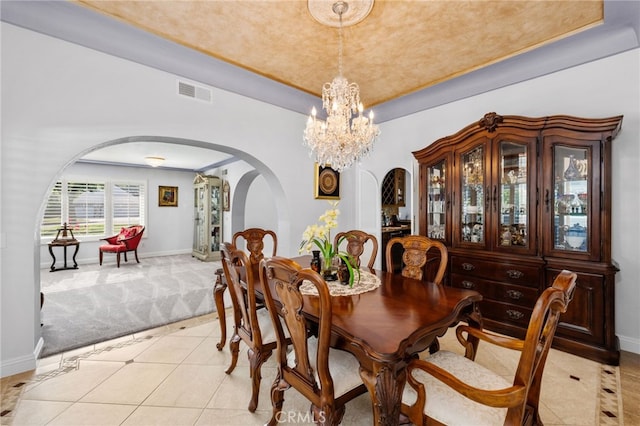 1738 N Ukiah Way, Upland, CA 91784 - dining area with arched walkways, light carpet, a chandelier, baseboards, and a tray ceiling