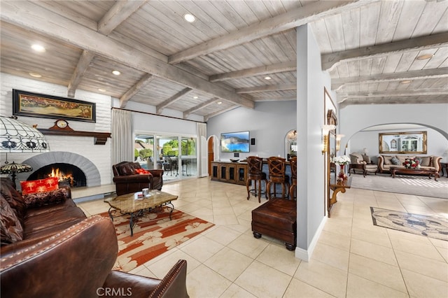 1738 N Ukiah Way, Upland, CA 91784 - living area with arched walkways, light tile patterned flooring, a fireplace, wood ceiling, and recessed lighting
